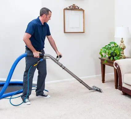 A carpet cleaning technician cleaning a home in Toronto